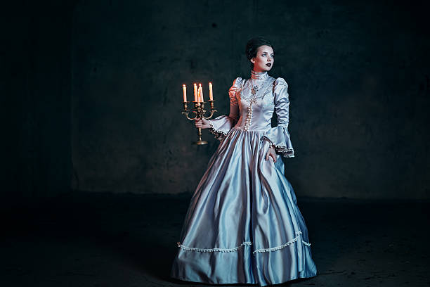 Woman in victorian dress Woman in victorian dress imprisoned in a dungeon candlestick holder photos stock pictures, royalty-free photos & images