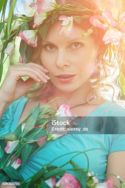 Attractive Tender Woman With Wreath On Head And Pink Flowers Stock Photo - Download Image Now