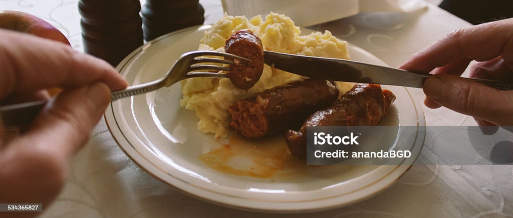 eating sausages and mash man eating sausages and mash potato 2015 Stock Photo