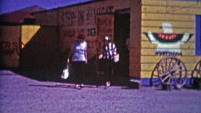 1964: Southwestern gift shop mother daughter family exits gravel parking lot.