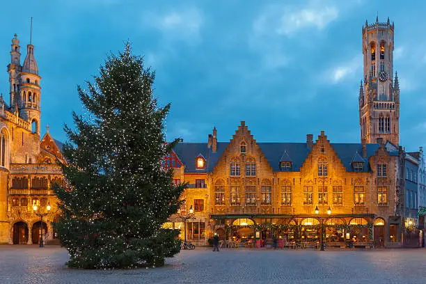 Scenic cityscape with the picturesque night medieval Christmas Burg Square in Bruges, Belgium