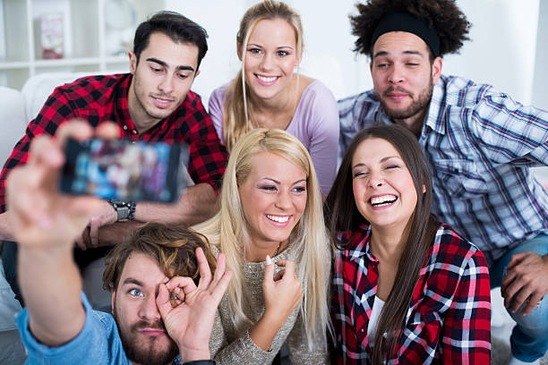 istock Group of multiethnic smiling friends doing a selfie 534367799