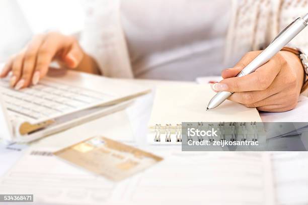 Womans Hand Checks Spreadsheet With Calculator Highlighters And Pen Stock Photo - Download Image Now