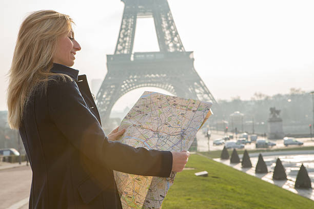 istock Young woman looking at map for directions-Paris-Eiffel tower 534369241