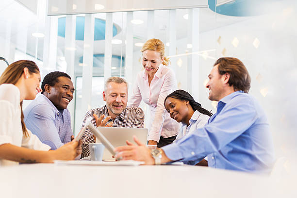 istock Happy business people using laptop in the office. 534369581