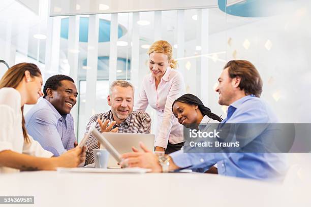 Happy Business People Using Laptop In The Office Stock Photo - Download Image Now - 2015, 30-39 Years, Adult