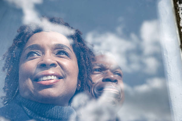 istock Couple looking out of a window 534369763