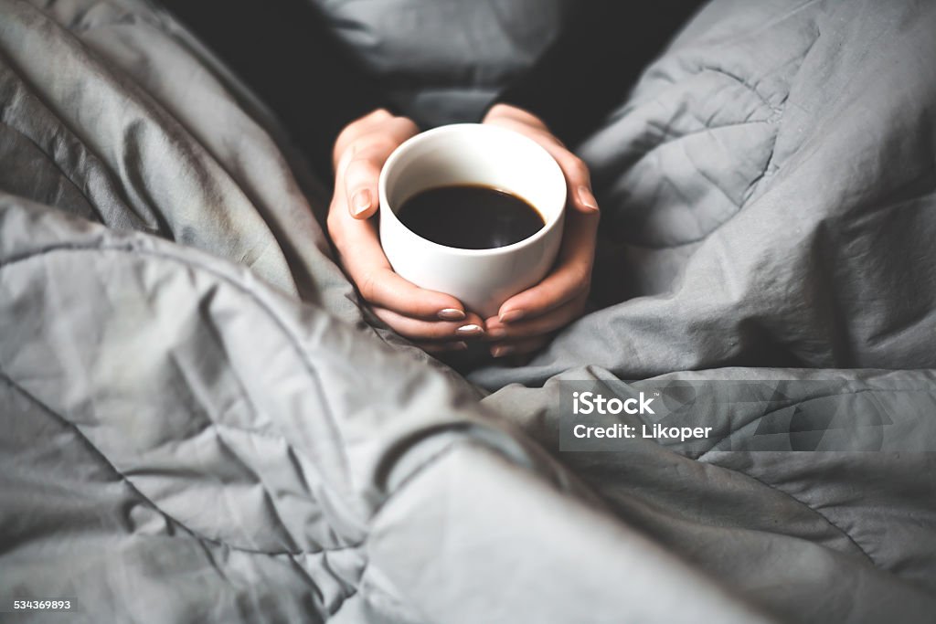 Woman holding a cup of coffee Woman's hands holding a cup full of coffee 2015 Stock Photo