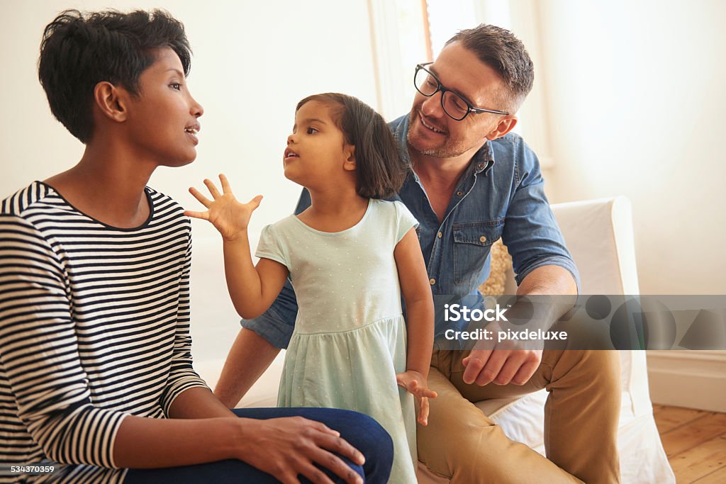 Mommy! Cropped shot of a family of three sitting on their living room sofa Family Stock Photo