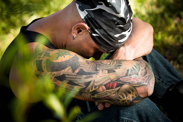 istock Characters: Sad man with tattoos and piercings contemplates. Nature. 534370531