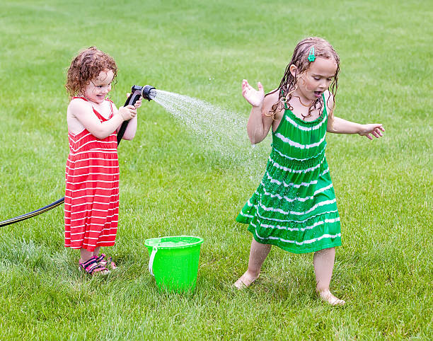 istock Girls Playing With Garden Hose 534370819