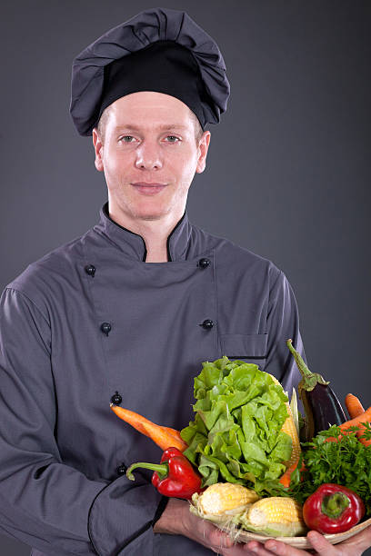 istock chef holding a basket of delicious fresh vegetables 534373163