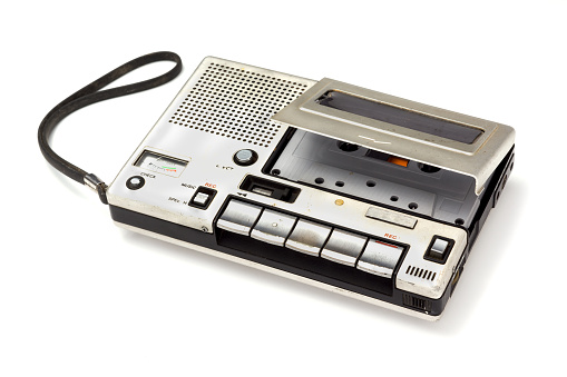 old cassette Tape player and recorder with audio cassette inside on white background