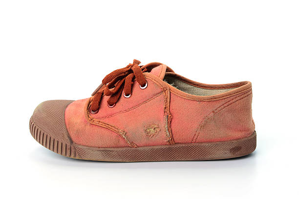 istock Old brown sneakers isolated on white background 534395754