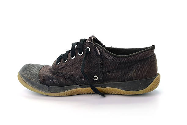 istock Old black sneakers isolated on white background 534395760