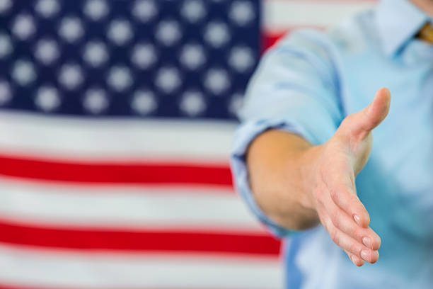istock Shaking hand in front of American flag 534395846