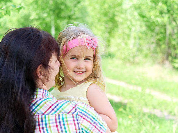 istock mother playing with her  little daughter on nature 534396570