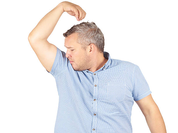 istock Fat man, smelling sniffing his armpit, something stinks bad, fou 534398246