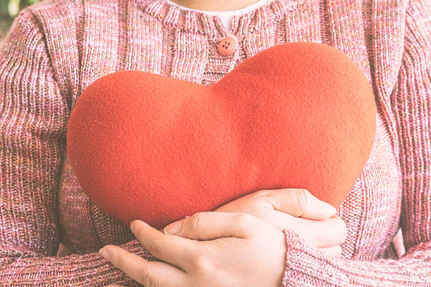 istock Red heart in woman hands 534398770