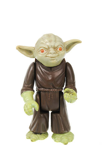 Adelaide, Australia - May 26, 2016: A studio shot of a Vintage Yoda Action Figure on a white background from the Star Wars universe. Star Wars is a very popular movie franchise worldwide and merchandise from Star Wars movies are highly sought after collectables.