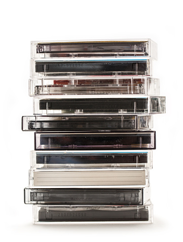 Stack of old cassettes on white background