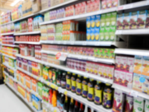 Natural Juice Bottles on Supermarket blurred background