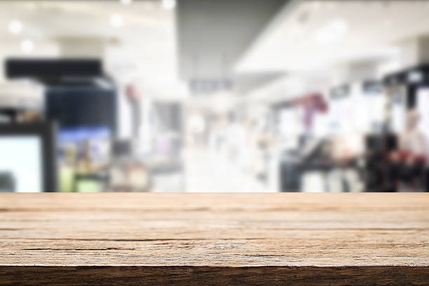Empty wooden table space and bokeh light of shopping mall. stock photo
