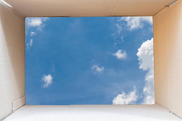 istock Inside of brown cardboard box with blue sky background 534403852