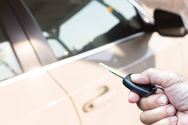 istock Men's hand presses on the remote control car key 534406894