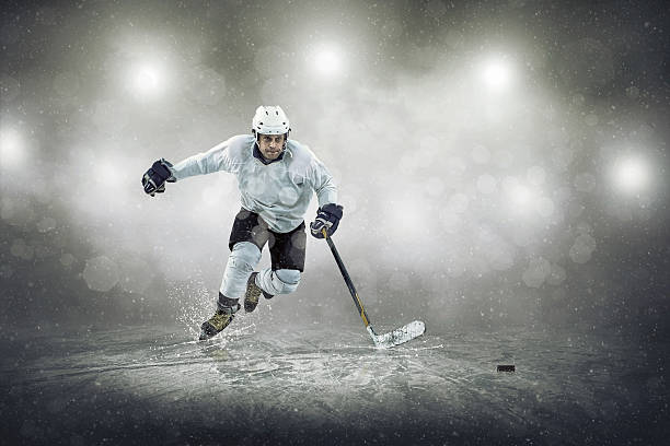 Ice hockey player on the ice, outdoors Ice hockey player on the ice, outdoors ice hockey stock pictures, royalty-free photos & images