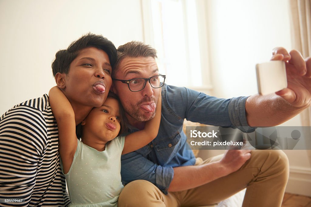 Silly selfie Cropped shot of a family of three taking a selfie with a cameraphone 2-3 Years Stock Photo