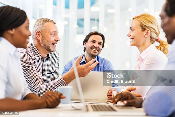 Happy Business People On A Meeting Stock Photo - Download Image Now - 2015, Adult, Adults Only