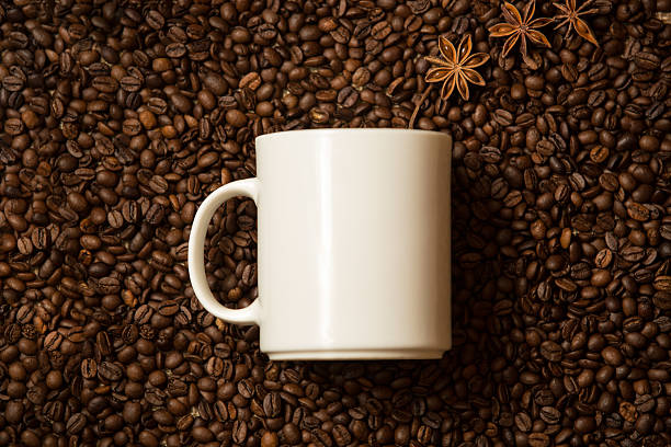 istock mug against coffee beans with anise stars lying like steam 534422663