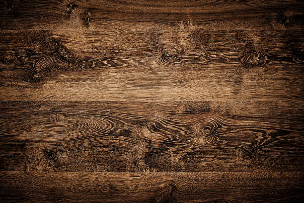 Overhead view of dark brown floor texture Overhead view of dark brown floor texture. A wood background with multiple planks placed close together.  The planks feature a variety of light and dark brown shades.  The darkest shades are on the corners, the lightest on the middle. There are variety of knots and swirls on it. half timbered photos stock pictures, royalty-free photos & images
