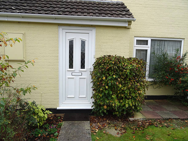 istock Typical 1980s terraced house, rendering (magnolia masonry-paint), white upvc front-door 534424079
