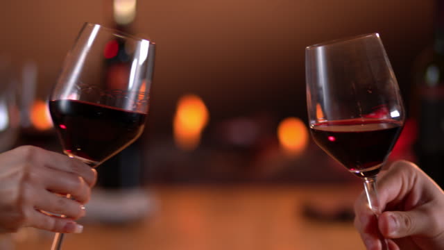 Slow motion toast with red wine