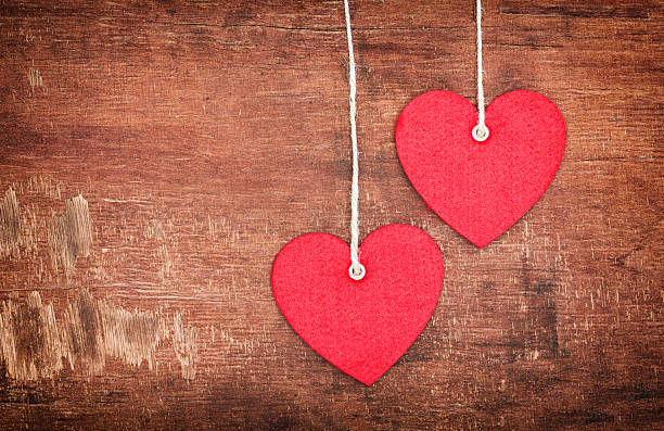 zwei textil pendent hearts - heart shape textile button hanging stock-fotos und bilder