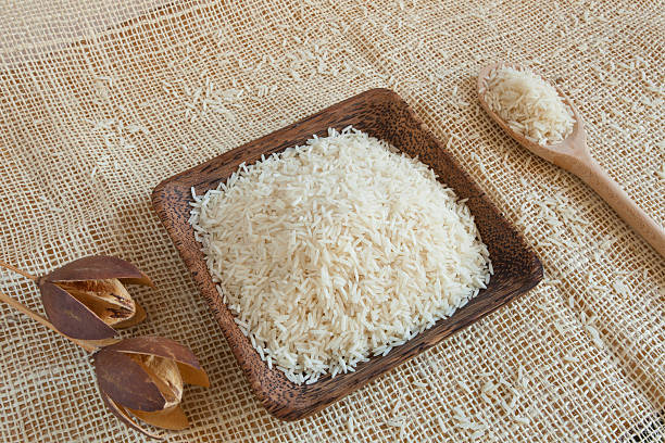 istock Uncooked Basmati rice in a wooden cup 534428563