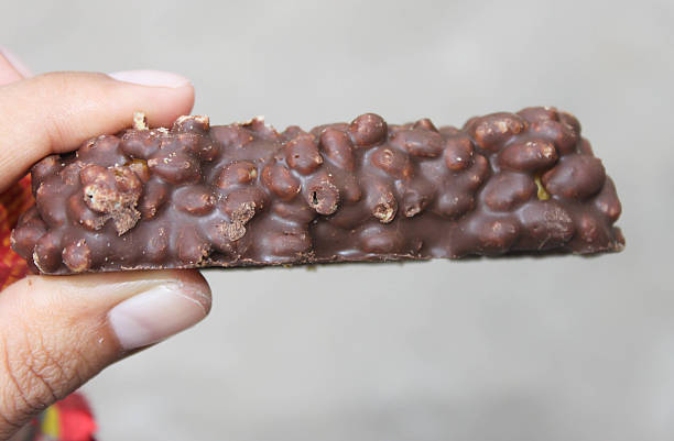 istock Hand holding a wafer chocolate with caramel mixture. 534429087