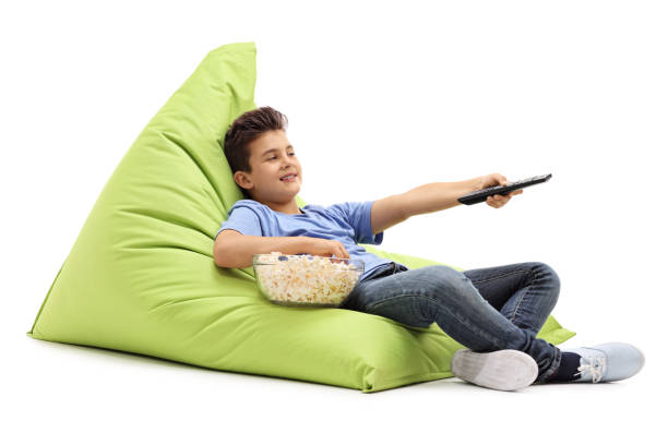 Little kid watching TV and eating popcorn