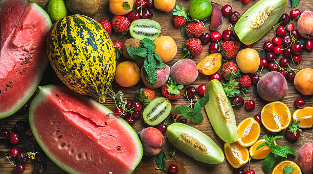 istock Various colorful tropical fruit selection on rustiv wooden background 534453400