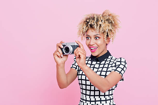istock Afro American young woman holding camera 534453914
