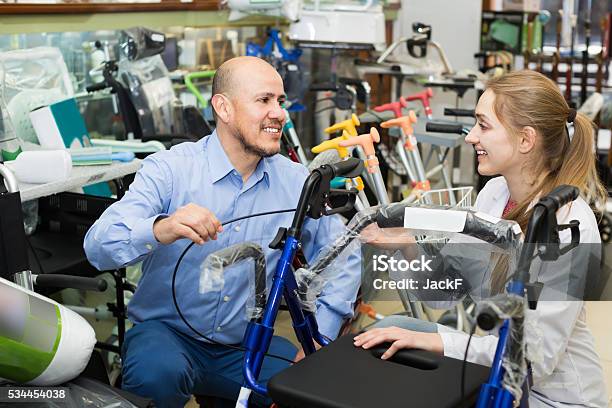 Client Asking Girl About Electric Wheelchairs Stock Photo - Download Image Now - Store, Wheelchair, Retail