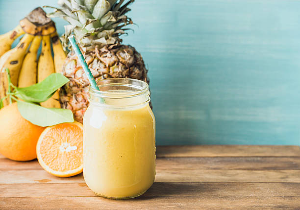 istock Freshly blended yellow and orange fruit smoothie in glass jar 534455162