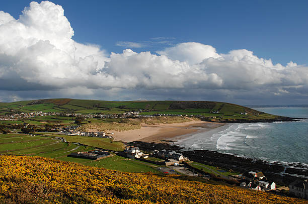 Croyde Bay Devon UK Beautiful Croyde Bay in Devon, under high summer sunshine. As seen from nearby Baggy Point and looking over a field of Gorse. croyde bay photos stock pictures, royalty-free photos & images