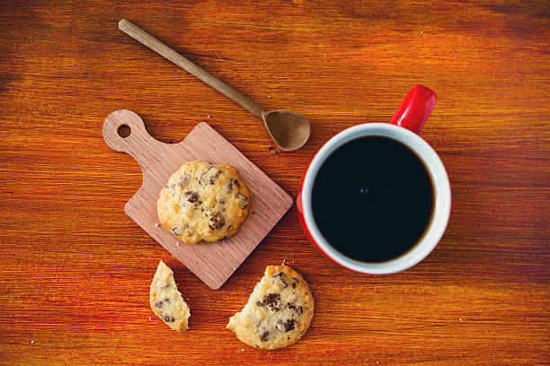 Mug of coffee and cookies on table