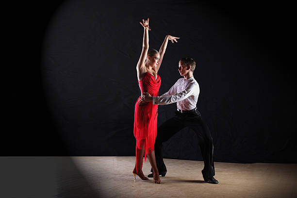 istock Latino dancers in ballroom isolated on black 534458172