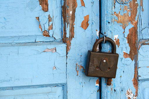 lock hangs on an old blue door