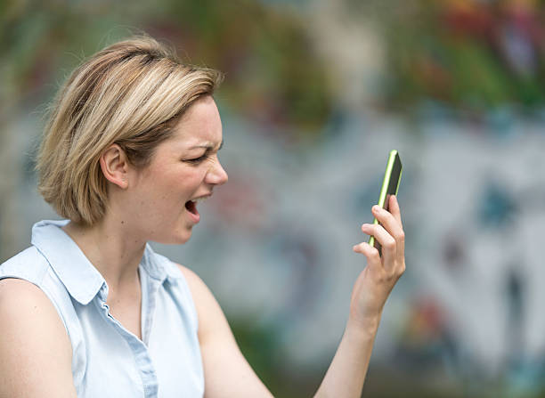 istock Woman screaming at her phone 534460128
