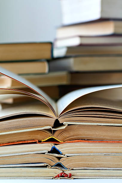 istock stacks of old opened books, closeup view 534460588